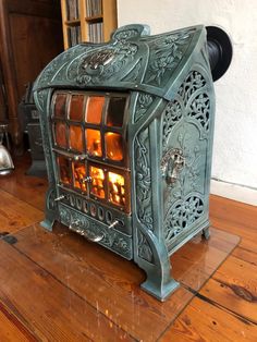 an old fashioned stove sitting on top of a wooden floor