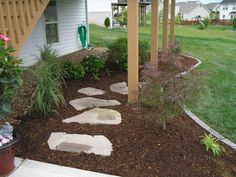 a garden area with stepping stones and flowers