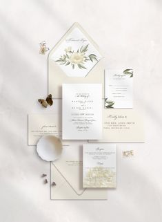 the wedding stationery is laid out on top of each other