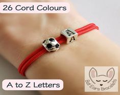 two bracelets with soccer balls on them and the words 26 cord colours at to z letters