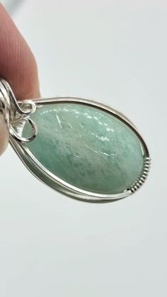 Nice amazonite cabochon-- see all pics especially close ups. Stone has a few areas of rough finish that flash with chatoyancy! Video found on my instagram @leetwraps This is made from .925 sterling silver. Ready to wear! Comes on an 18 inch stainless steel chain as seen in the photos... also comes in a gift box and with a polishing cloth. Unique Silver Amazonite Jewelry, Handmade Silver Aventurine Jewelry, Handmade Silver Amazonite Necklace, Handmade Oval Jade Pendant, Silver Amazonite Jewelry With Natural Stones, Wire Jewelry Designs, Steel Chain, Sterling Silver Necklace, Stainless Steel Chain