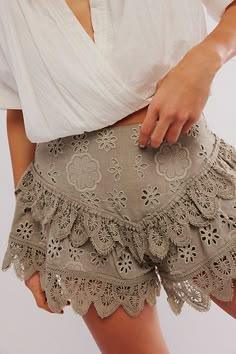 Forever femme with delicate detailing, these sweets shorts from our Bali collection will turn heads with every wear. **Fit:** Mid-rise, dropped tiered silhouette **Features:** Elastic waistband for pull-on ease, dropped basque waist, eyelet lace detailing, scalloped trimming **Why We ❤ It:** Timeless with western boots or off-duty with sporty sneakers, this pair has endless ways to wear. | Bali Warm Nights Embroided Shorts at Free People in Green, Size: L Country Shorts, Lace Short Outfits, Shorts Summer Outfit, Basque Waist, Summer Shorts Outfits, Sporty Sneakers, Free People Clothing, Embroidered Shorts, London Fog