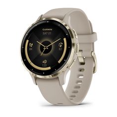 the garmin smart watch is shown in gold and grey with an analog display on its face