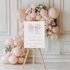 a welcome sign with balloons and flowers in front of a backdrop that says welcome to the baby shower