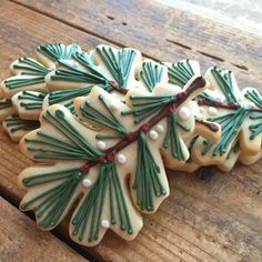 decorated cookies are sitting on a wooden table