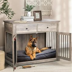 a dog laying on top of a bed in a room next to a wooden table