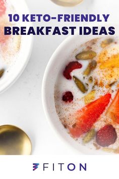 two white bowls filled with fruit and yogurt on top of a table next to spoons