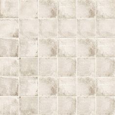 a white tile wall with square tiles on the bottom and one side that is very light gray