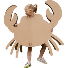 a woman sitting on top of a cardboard crab