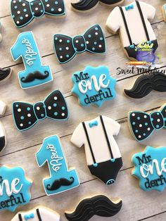 decorated cookies are arranged in the shape of mustaches, bow ties and one - year ones