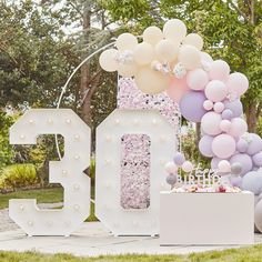 balloons and decorations are displayed in front of the number 50 sign