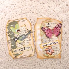 two small tags with butterflies on them