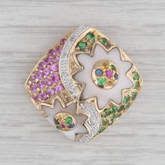 Gemstone Information: - Natural Mother of Pearl -  Cut - Star Shapes Color - White - Natural Sapphires, Rubies, Tsavorites - Total Carats - 1.11ctw Cut - Round Brilliant Color - Multicolor Metal: 14k Yellow Gold Weight: 6.4 Grams  Stamps: 14k JCR Measurements: 25.7 x 25.2 mm The bail will accommodate up to a 3.8 mm chain. Each piece is thoroughly examined and refinished as needed by our professional jewelers, graded by our in-house GIA (Gemological Institute of America) Graduate Gemologist, and Luxury White Multi-stone Gemstones, Mens Custom Jewelry, Silver Flatware, Ruby Jewelry, Ruby Gemstone, Natural Sapphire, Fine Jewellery Necklace, Heel Boots, Estate Jewelry