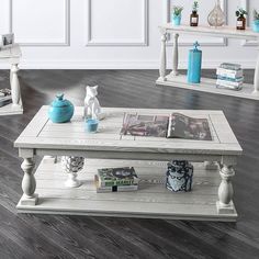 a white coffee table sitting on top of a hard wood floor next to two end tables