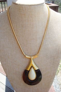 "Another stylish and versatile pendant necklace from Trifari. The lucite teardrop pendant has a cream colored teardrop rimmed in gold inside of a larger tortoise shell brown teardrop. The top of the brown teardrop is capped in shiny gold. The pendant hangs from a goldtone snake chain. The pendant measures 3 1/2 inches long and 2 inches wide at the bottom. The chain necklace measures 18 inches and closes with a spring ring. The pendant is signed Trifari with a crown over the \"T\". Excellent cond Crown Trifari, Teardrop Pendant, Creative Jewelry, Snake Chain, Tortoise Shell, Gold Beads, Spring Rings, Jewelry Ideas, Tortoise