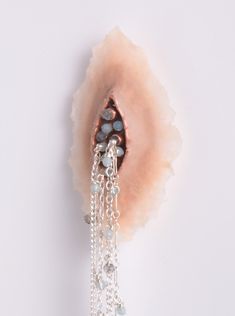 an earring with beads hanging from it's side