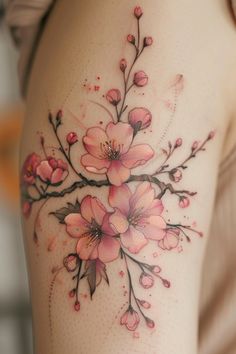 a woman's thigh with pink flowers on it