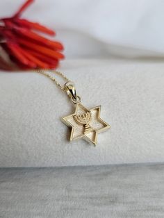 This 14k gold pendant of a temple Menorah is the main feature of this Star of David. The border of the six-pointed star, eternal symbol of the Jewish people, is marked by lines of textured gold. Enjoy wearing this "Magen David" every day. The emblem of the Jewish people, a six-pointed star, is studded with a decorative border, giving the appearance of a shield.  Indeed, this Star of David is also called "David's Shield."  It is believed that David's shield was decorated in biblical times with a Elegant Yellow Gold Star Of David Necklace, Elegant Star Of David Necklace, Gold Star Of David Spiritual Necklace, Yellow Gold Star Of David Necklace, 14k Gold Star Of David Necklace, Tarnish Resistant, Judaica Jewelry, Jewish Jewelry, Tiny Pendant, Roman Glass