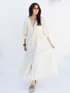 The Southern Star Maxi Shirtdress in Egret is a wardrobe essential for year-round styling. Crafted from shirred striped cotton, it can be worn as a duster layered over fall outfits or buttoned up as a breezy maxi dress or bathing suit cover up in summer. The hidden waist ties allow for versatility, offering both a relaxed or fitted look. Cotton Maxi Shirt Dress For Beach, Cotton Maxi Shirt Dress For The Beach, Chic Cotton Maxi Shirt Dress, Cotton Maxi Length Shirt Dress For Daywear, Cotton Maxi Shirt Dress For Daywear, Summer Cotton Maxi Shirt Dress, White Billowy Long Sleeve Maxi Dress, Relaxed Fit Maxi Shirt Dress For Daywear, Chic Relaxed Fit Maxi Dress