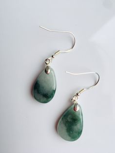 A pair of real green&white jade teardrop earrings with 925 Sterling Silver hook. The simple and delicate teardrop earrins are carved from Grade-A quality green icy jade. The jade color is all-natural and genuine, clear jade texture can be easily observed under the daylight. Some highlights of this pair of minimalistic jade earrings: *High quality guaranteed. Grade-A natural green jade, handmade with 925 sterling silver. *Graceful and simple teardrop design *Each teardrop is measured around 1 Green Drop Jewelry For Jewelry Making, Green Pear-shaped Gemstone Earrings, Pear-shaped Green Gemstone Earrings, Green Pear-shaped Teardrop Earrings, Green Teardrop Drop Earrings For Jewelry Making, Green Teardrop Pendant Jewelry With Matching Earrings, Nickel-free Green Drop Jewelry, Green Nickel-free Drop Jewelry, Dangle Jade Earrings With Matching Set