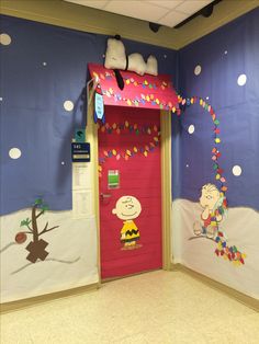 a door decorated with peanuts and charlie brown on the wall next to a red door