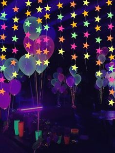 stars and balloons are hanging from the ceiling