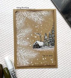 a handmade christmas card with white snow on the ground and pine trees in the background