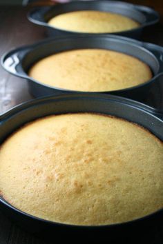 three round pans filled with cake batter on top of a table