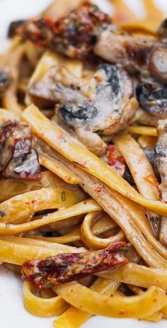 pasta with mushrooms and sauce on a white plate