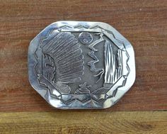 Navajo sterling silver belt buckle.3 1/2" wide x 3" tall.Fits a 1 1/2" or more narrow belt.Signed BCT. Robert Becenti Jr. and stamped sterling.The design is a Yei mask, sun, lightning bolt and rock formation.Good condition. Nice stamp work around the edge.Bkl 1 Silver Hand Tooled Adjustable Belt Buckles, Vintage Silver Hand Tooled Belt Buckles, Silver Western Belt Buckles, Artisan Adjustable Silver Belt Buckles, Artisan Silver Adjustable Belt Buckles, Vintage Silver Concho Belt Buckles, Adjustable Southwestern Silver Belt, Vintage Silver Belt Buckles For Rodeo, Adjustable Silver Southwestern Belt Buckles