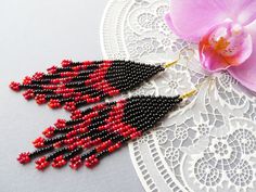 Long Red Black tassel earrings Seed bead tassel earrings Beaded earrings Dangle Fringe earrings American Indian style Statement earrings These earrings are perfect for the creation of evening and daily image. They are very light weight and measure about 4". By your order, earrings can be made other colors and lengths. Please, write about it in the personal massage. Please note that due to lighting effects, monitor's brightness, contrast and other parameters of the photo may be slight differences in the colors on this product. The order is sent in a beautiful gift box. Beaded jewelry requires careful and loving care. And then you will enjoy it for a long time!  Shipping: Air mail with tracking.  Delivery in the US usually takes 14-20 days.  Europe usually takes 14 days.  Australia - 14 days Seed Bead Tassel Earrings, Bead Tassel Earrings, Beading Crafts, Types Of Earrings, Blue Dangle Earrings, Beaded Tassel Earrings, Earrings Beaded, Earrings Pink, Long Red