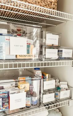 an organized pantry with clear bins and labels on the bottom shelf for food items