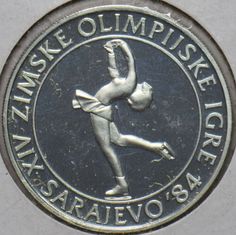 an olympic medal with a figure on the front and back side, in silver color