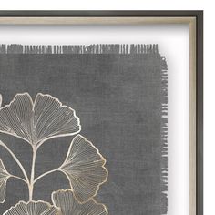 an art work with gold leaf designs on grey linen, framed in a wooden frame