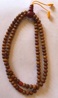 This small sandal wood mala has three traditional decoration beads and guru beads. It is from Nepal and nice and beautiful mala. it is 11 inches long mala. Holistic Wooden Beads Mala For Rituals, Holistic Wooden Mala For Rituals, Holistic Healing Mala With Wooden Beads, Traditional Wooden Beaded Bracelets For Meditation, Traditional Wooden Beaded Bracelets, Spiritual Wooden Beads Rosary For Meditation, Spiritual Rosary With Wooden Beads For Meditation, Brown Mala With 8mm Beads For Puja, Hand-strung Brown Mala For Healing