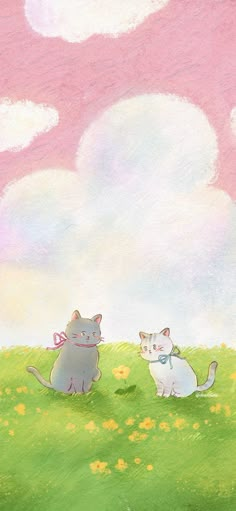 two cats are sitting in the grass on a sunny day