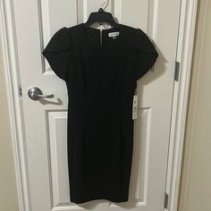 Women’s Calvin Klein Black Dress, Brand New. Size 6 Chic Calvin Klein Short Sleeve Mini Dress, Calvin Klein Formal Mini Length Dress, Formal Calvin Klein Mini Dress, Calvin Klein Formal Mini Dress, Calvin Klein Short Sleeve Midi Dress For Evening, Calvin Klein Knee-length Midi Dress For Night Out, Calvin Klein Short Sleeve Midi Dress For Party, Calvin Klein Black Short Sleeve Dress, Elegant Black Calvin Klein Dress