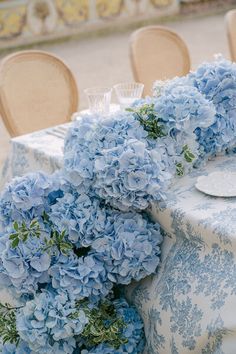 blue hydrangeas are arranged on the table for an elegant wedding breakfast or reception