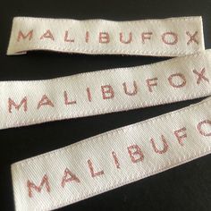 three white labels that say mailbox and malbufox on them, sitting next to each other