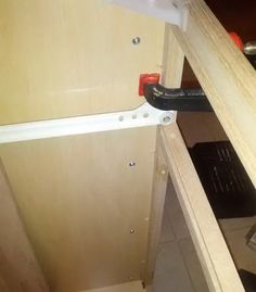 an open cabinet door with tools in it