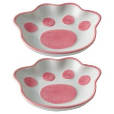 two pink and white bowls with paw prints on the bottom, one bowl is shaped like a cat's paw