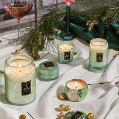 candles and ornaments on a table with wine glasses