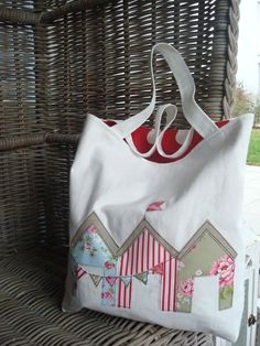 a white bag sitting on top of a wicker chair