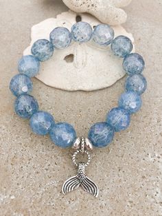 Simple yet Chic. This coastal bracelet is amazing. These beautiful quality faceted Picasso glass beads are a beautiful warm blue and are finished off with two Hammered silver spacer beads and a fabulous steak g silver Mermaid Tail charm. Overall, this is a lovely piece to add to any beach lovers coastal jewelry collection, Materials: 12mm Faceted Glass Beads Silver Spacer beads Sterling Silver Mermaid Charm Bracelet length comes in various sizes, see drop down menu for your preference, please se Coastal Bracelet, Silver Mermaid Tail, Coastal Jewelry, Picture Album, Mermaid Bracelet, Silver Mermaid, Soft Boy, Beach Bracelets, Beads Bracelet Design