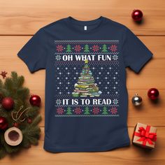 a christmas t - shirt with the words oh what fun it is to read on it