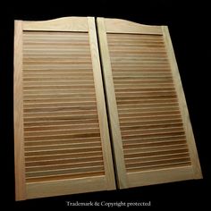 two wooden shutters are shown against a black background