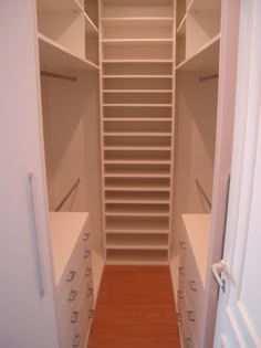 an empty walk in closet with lots of drawers