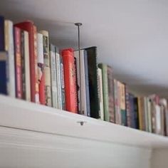 there are many books lined up on the shelf