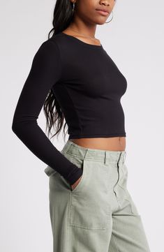 Svelte and stretchy, this finely ribbed crop top is the perfect match for high-rise styles and is polished off by a graceful scoop neckline. 17 1/2" length (size Medium)   Scoop neck   Long sleeves   97% Lenzing™ EcoVero™ viscose, 3% spandex   Lenzing EcoVero viscose is a sustainably produced fiber using pulp made from renewable wood sources and certified with the EU Ecolabel for high environmental standards, including lower emissions and water usage than generic viscose   Machine wash, dry flat Fall Seamless Cropped Top, Basic Crop Top For Fall, Seamless Crop Top For Fall, Fitted Slightly Cropped Tops For Fall, Trendy Fall Crop Top, Ribbed Fitted Crop Top, Crew Neck Elastane Crop Top With Stretch, Trendy Seamless Crop Top For Fall, Fitted Ribbed Crop Top In Elastane