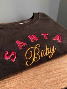 Handmade embroidered Santa Baby Christmas design onto unisex sweatshirt ✯PRODUCT DETAILS✯ Please note: The photos taken are only indicative every single top is completely handmade therefore all unique! ✯ECO SWEATSHIRT✯  Currently only available in Size Small, Medium and Large  The eco sustainable sweatshirt is made to a very high quality, it's crafted from premium organic and recycled fabrics.  It's 350gsm (so nice and thick) and the inside is a super soft brushed fabric, so will keep you nice a Sweatshirt Ideas, Sweatshirt Embroidery, Embroidered Christmas, Christmas Jumper, Embroidery Sweatshirt, Embroidered Crewneck, Hoodie Material, Santa Baby